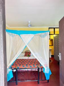 a bed with a canopy in a room at Juani beach bungalows in Kilindoni +226 photos