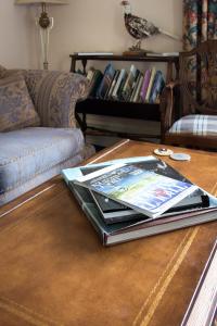 a book on a coffee table in a living room at Whitehouse Country House in Saint Boswells