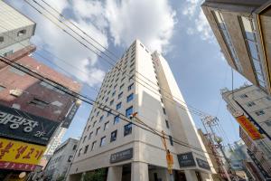 a tall building in the middle of a city at H-AVENUE HOTEL Yeongdeungpo in Seoul