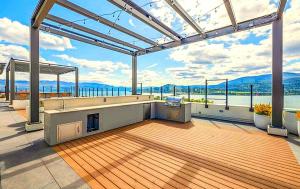 a large deck with a view of the water at Alice in Kelowna in Kelowna