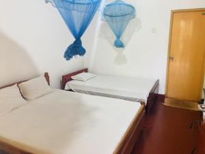 Postelja oz. postelje v sobi nastanitve Nugasewana Guest