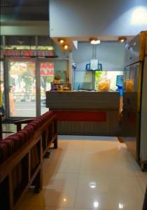 a fast food restaurant with a counter and benches at Rubikz Hostel & Cafe in Surabaya
