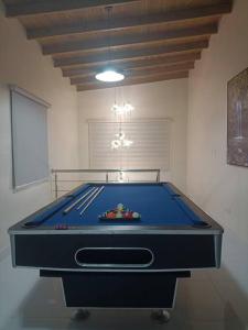 a blue pool table in a room with a ceiling at Estrella de luz penthouse a estrenar in Santiago de los Caballeros