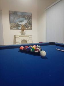 a blue pool table with balls in the middle at Estrella de luz penthouse a estrenar in Santiago de los Caballeros