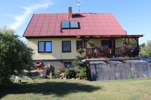 a house with a red roof and a fence at Apartment Příbram in Příbram