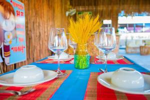 a table with plates and wine glasses on it at SEA SAND RESORT in Kampot