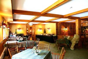 a restaurant with tables and chairs in a room at Northern Lights Lodge in Stowe