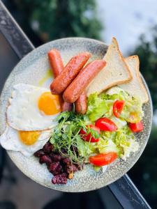 a plate of food with eggs sausage and salad at Zhytomyr palace mimino in Zhytomyr