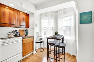 a kitchen with a stove and a table with stools at Private Remodeled Studio In Vibrant Center City in Philadelphia