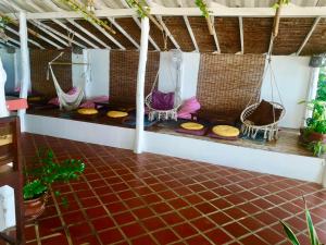 an outdoor room with hammocks and a tiled floor at SeaEsta Beach in Ban Tai