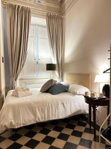 a bedroom with a large bed with a window at The Street River in Pisa