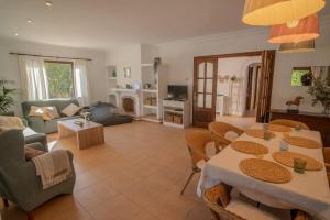 a living room with a table and chairs at Villa Cal Peso in Port de Pollensa