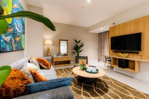 a living room with a couch and a tv at Zenity Luxury Apartment in District 1 since 2024 in Ho Chi Minh City