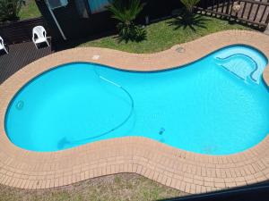 an overhead view of a large blue swimming pool at St. Lucia Ocean View Holiday Home in St Lucia