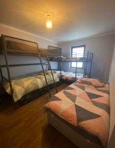 a bedroom with two bunk beds and a window at Dublin Airport Big rooms with bathroom outside room - kitchen only 7 days reservation in Dublin