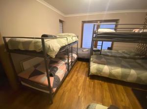 a room with two bunk beds and a window at Dublin Airport Big rooms with bathroom outside room - kitchen only 7 days reservation in Dublin