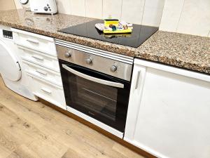 a kitchen counter with a toy on top of a oven at Albufeira Old Town T3 with Balcony in Albufeira