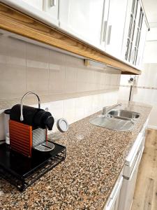 a kitchen with a sink and a counter top at Albufeira Old Town T3 with Balcony in Albufeira