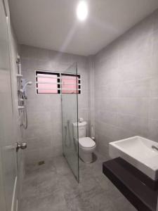a bathroom with a shower and a toilet and a sink at Ipoh Tambun Sunway next to Heaven Spacious Luxury Home in Kampong Batu Lapan