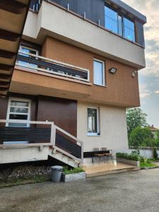 a building with a bench and a table in front of it at Villa Sarajevo Heights ex Villa Kolonija in Sarajevo