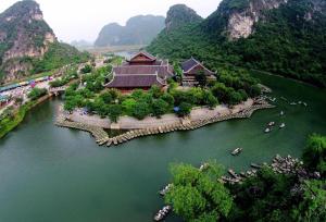 an aerial view of a resort on a river with mountains at Trang An Nature View Homestay in Nguyên Ngoại