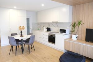 a kitchen and dining room with a table and chairs at CBD Japanese Retreat 2BR 1P Brekky Wifi Netflix in Canberra