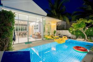 a swimming pool with a rubber duck in a house at Near Beach Three Pool villa 3 in Cha Am