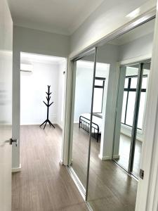 a room with sliding glass doors and a tree in it at Townhouse in West Footscray in Seddon
