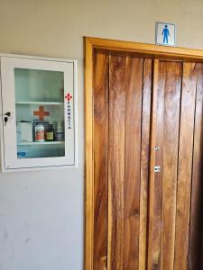 a wooden door in a room with a picture on the wall at Santa Filomena Camping in Descalvado