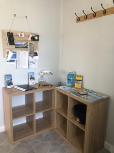 two wooden desks in a room with a wall at Cottage 32 in Lakes Entrance