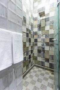 a bathroom with a shower with a glass door at Lazur Hotel Apartments in Hurghada