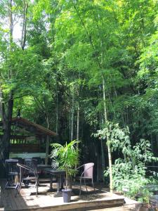 a patio with a table and chairs and trees at Hakone Mori No Yado in Hakone