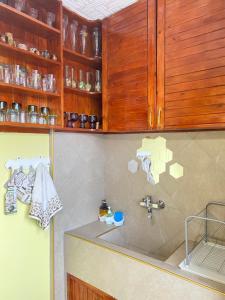a kitchen with a sink and wooden cabinets at Апартамент Панорама Трявна - кът за отдих, въздухолечение и почивка in Tryavna