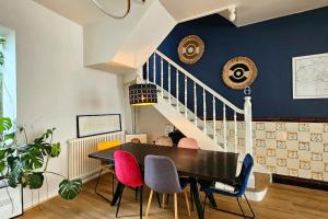 a dining room with a black table and colorful chairs at Maison de Caractère 8 pers - Jardin - in Lambersart