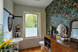 a bathroom with a sink and a toilet and a window at Maison de Caractère 8 pers - Jardin - in Lambersart +34 photos