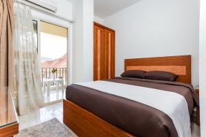 a bedroom with a bed and a large window at Lazur Hotel Apartments in Hurghada