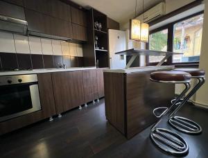 a kitchen with a bar stool in a kitchen at Urban Oasis: Central Location in Bucharest