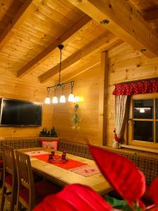 a wooden dining room with a table and a tv at Chalet - Urlaub bei Freunden in Wagrain