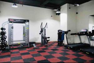 a gym with several treadmills and machines in a room at Full sea view with balcony with 5 stars hotel exceptional entertainment - Studio Apartment - 10 min to JBR - in Dubai