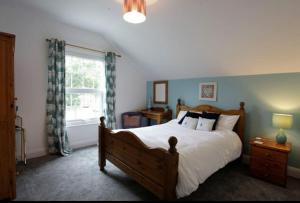 a bedroom with a large bed and a window at Seaglass Cottage - Redcar in Redcar