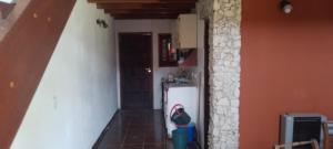 a small kitchen with a refrigerator and a hallway at Casa en el faro sona sur asta 5 plazas in Mar del Plata