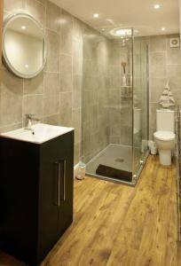 a bathroom with a shower and a sink and a toilet at Seaglass Cottage - Redcar in Redcar