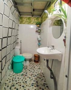 a bathroom with a sink and a toilet and a mirror at WINDY HILL VŨNG TÀU HOMESTAY in Vung Tau