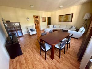 a living room with a table and chairs and a couch at Huge two floor apartment on the Park Colonnade with free parking for one car, 160 sqm in Karlovy Vary