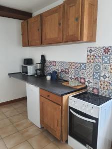 a kitchen with a stove and a white stove top oven at La Maison Nasona in Bresles +7 photos