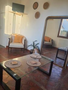 a living room with a coffee table and a mirror at La Maison Nasona in Bresles