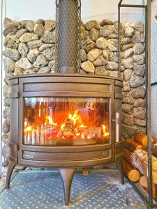 a fireplace in a room with a stone wall at OROJEJU in Seogwipo