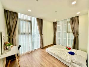 a bedroom with a bed and large windows at Ecogreen HCM - DPL Homestay SG in Ho Chi Minh City