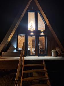 a house with a staircase in front of a window at Zibran Cabane in Bran