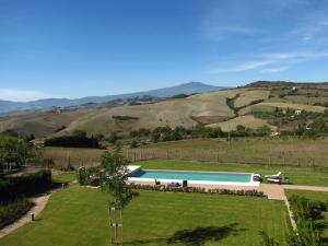 a swimming pool in the middle of a grassy field at Fonteliving in San Casciano dei Bagni